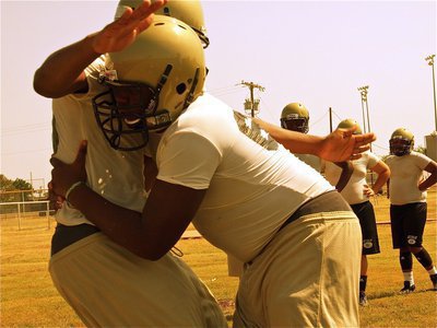 Image: Adrian Reed form tackles a teammate during drills.