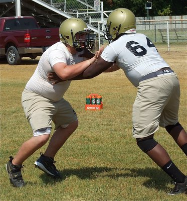 Image: Kelton Bales and Adrian Reed(64) mix it up in the trenches.