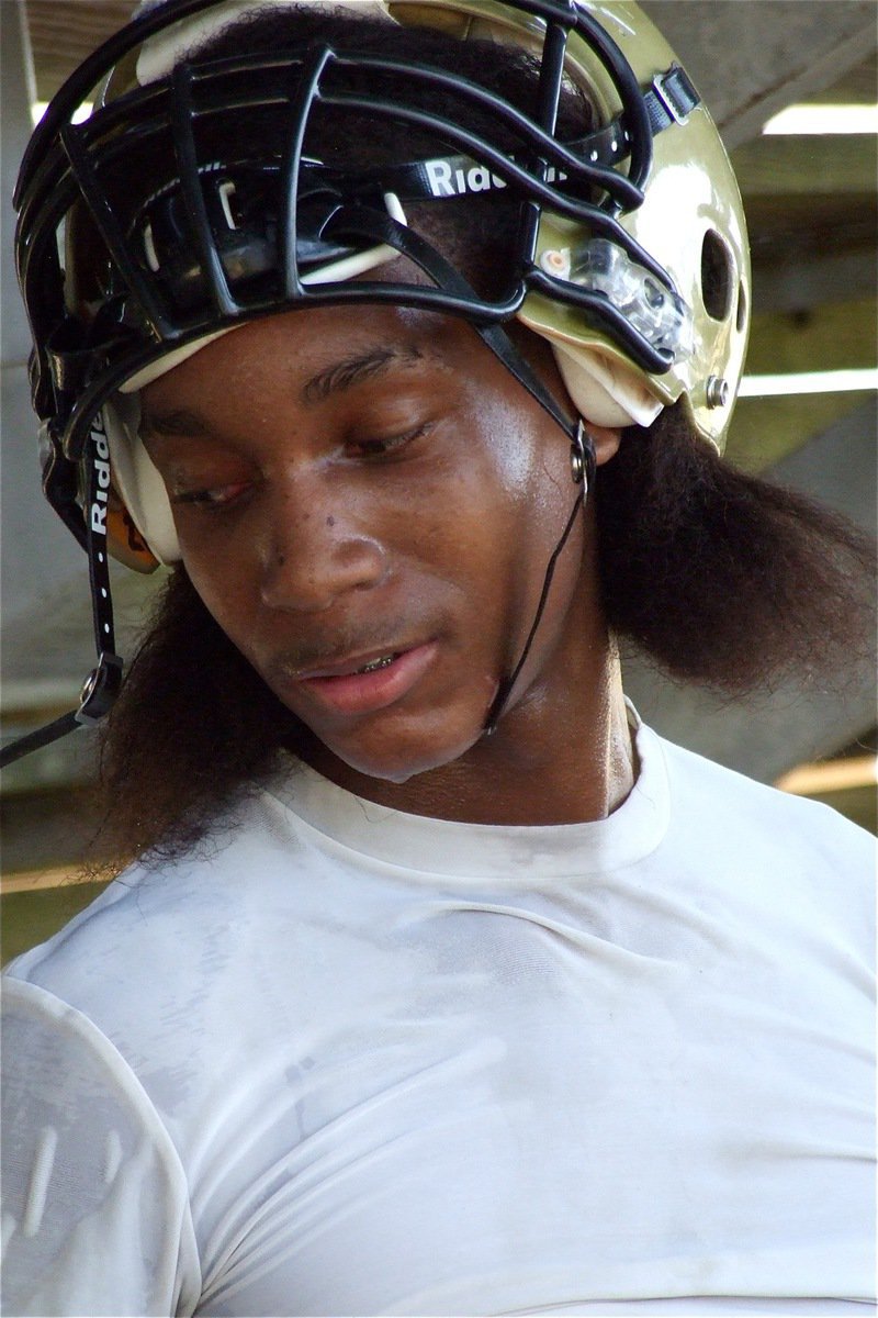 Image: Trevon Robertson tries to get rehydrated during a break in the action.