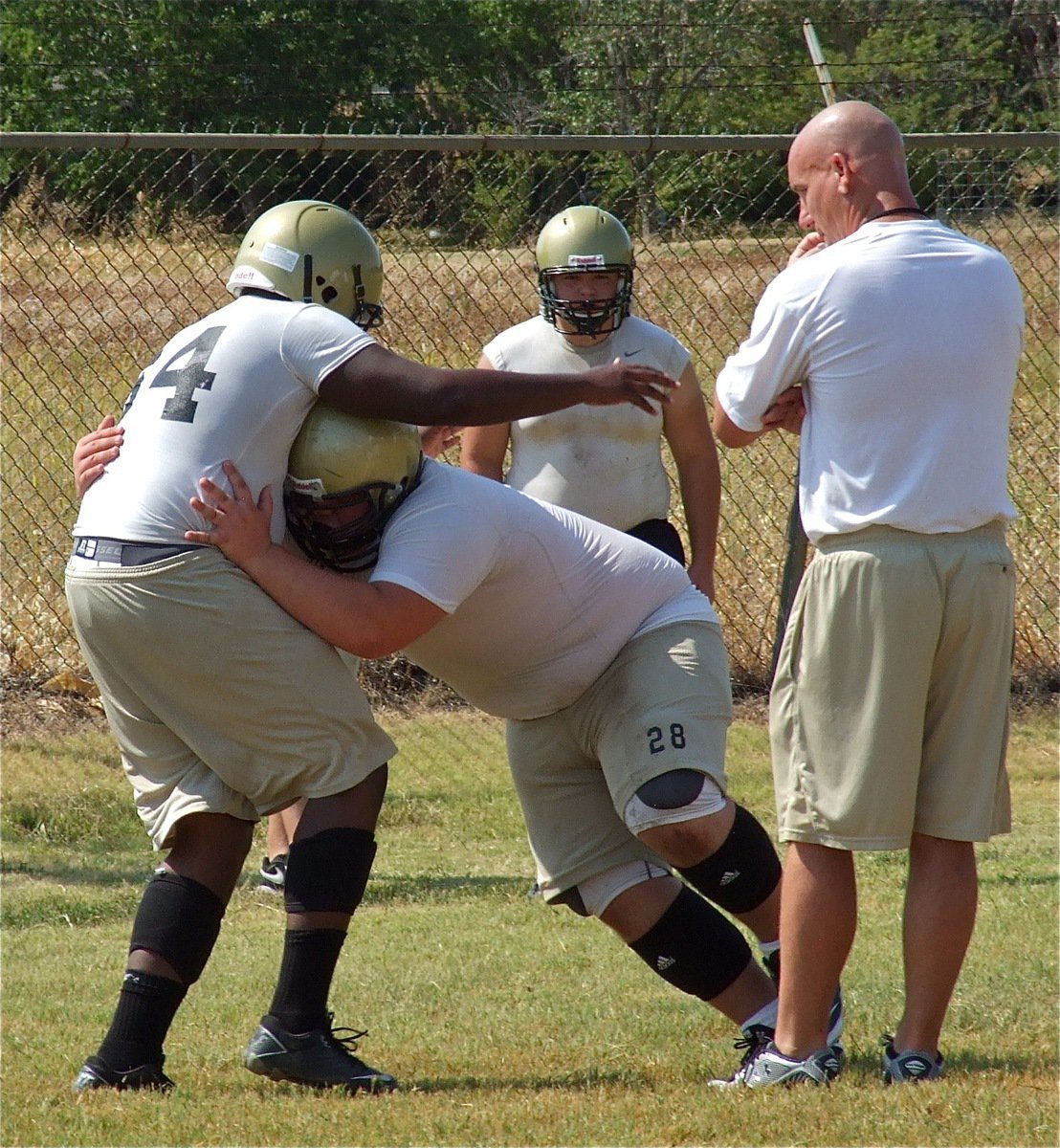 Image: We would like to leave all the opposing centers in the district with this image of Hank Seabolt steamrolling his way thru a runner. Kevin Roldan and Coach Jeff Richters look on as Adrian Reed(64) makes the sacrifice.