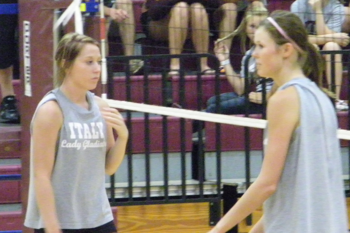 Image: Senior Leadership — Kaitlyn Rossa and Bailey Bumpus await a serve from a teammate.