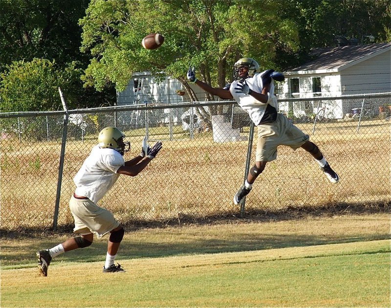 Image: Cornerback Eric Carson deflects a pass during defensive secondary drills. 