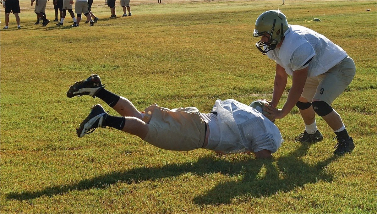 Image: Linebacker Ethan Saxon fights off a cut block.