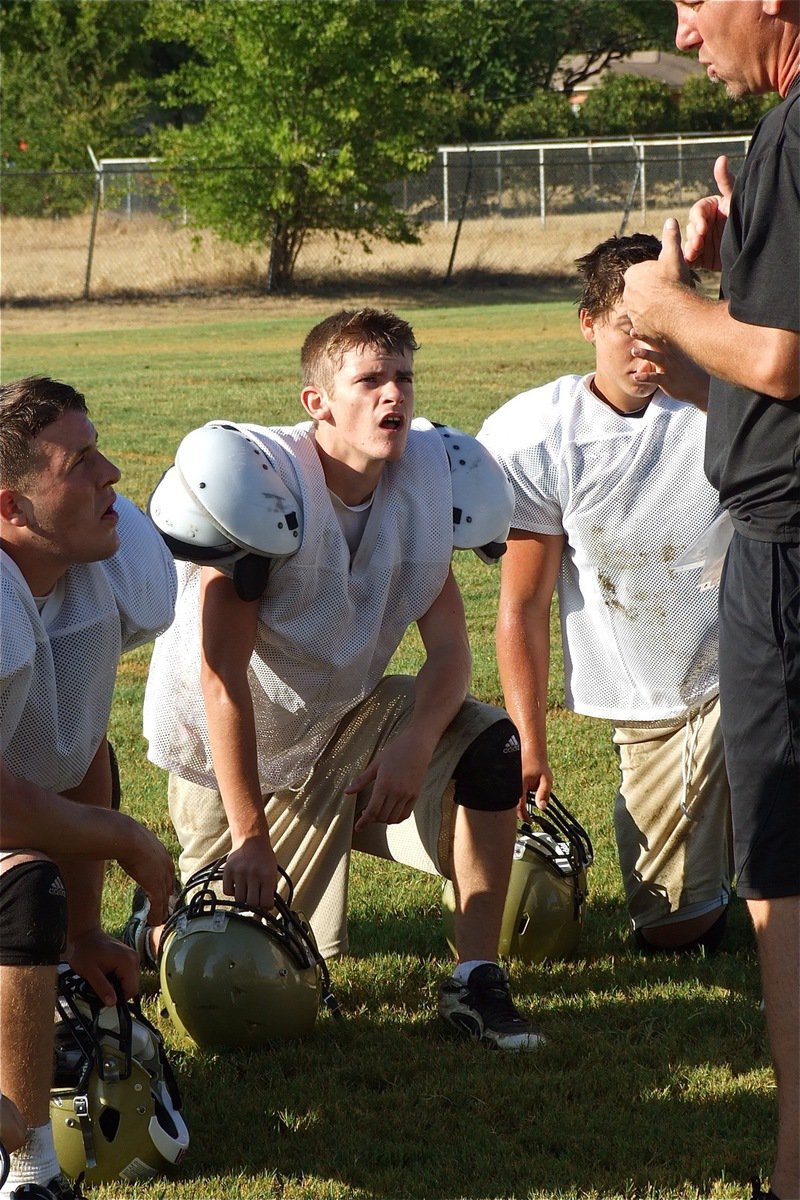 Image: Ethan Saxon, Justin Wood and Kyle Jackson get instruction from coach Jeff Richters.