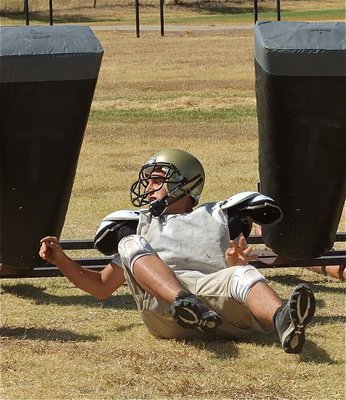 Image: Cody Medrano rolls down the line during sled drills.