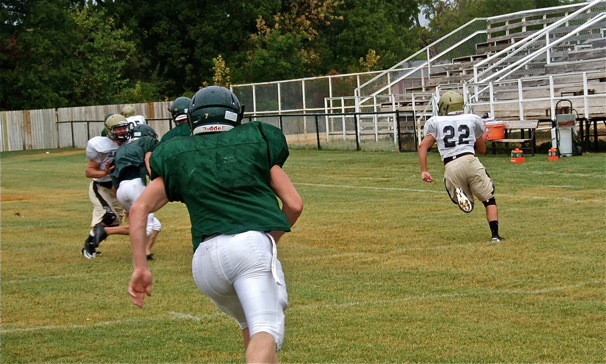 Image: Downfield blockers Ethan Saxon and Paul Harris help running back Kyle Jackson(22) gain ground.