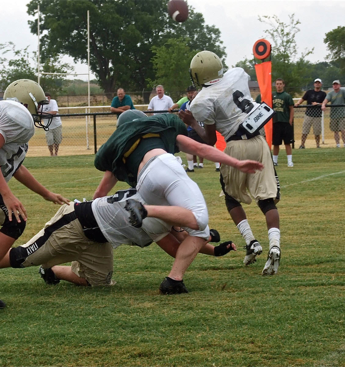 Image: Bailey Walton(54) and fellow offensive lineman Zain Byers(56) buy quarterback Eric Carson(6) time to pass.