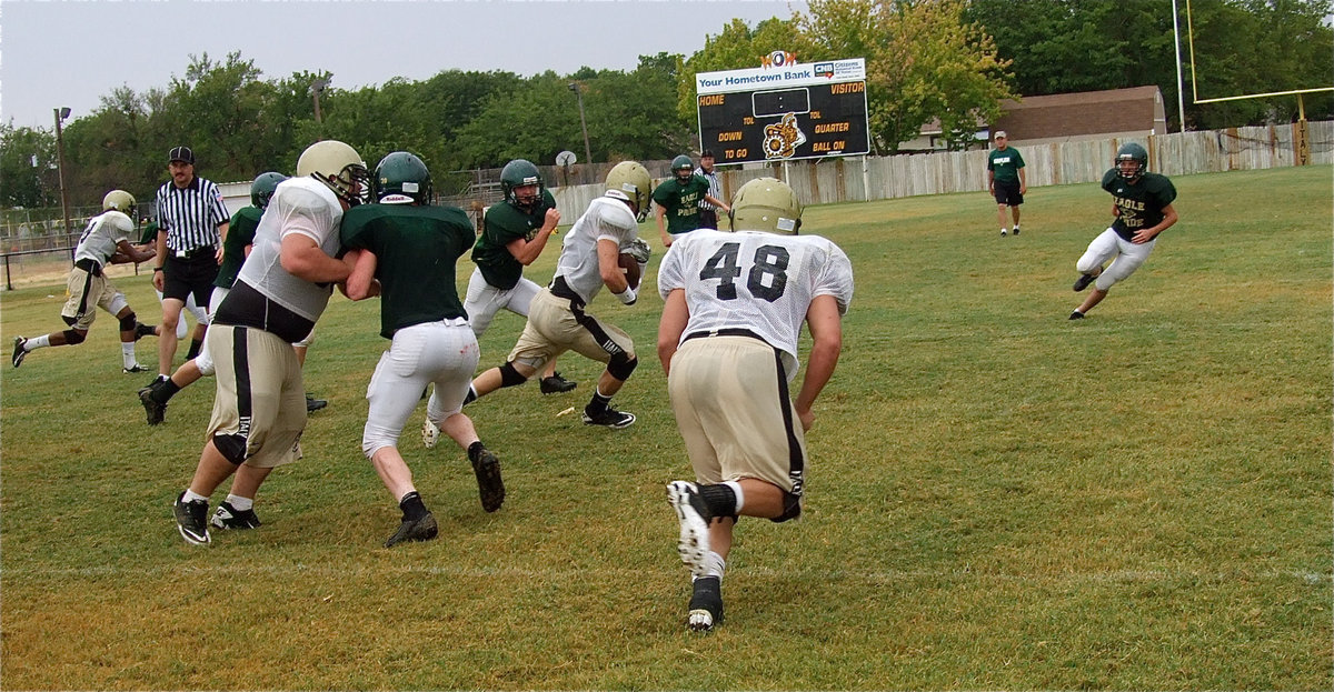 Image: Hank Seabolt clears room for Chase Hamilton who picks up yards against the Eagles.