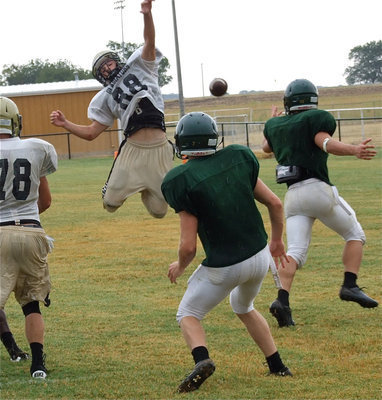 Image: Hayden Woods(88) gets higher than the Eagles to defend on a pass attempt.