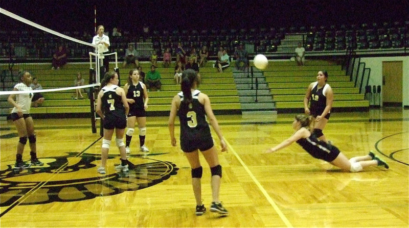 Image: Paige Westbrook digs deep to keep the ball alive for the JV Lady Gladiators.