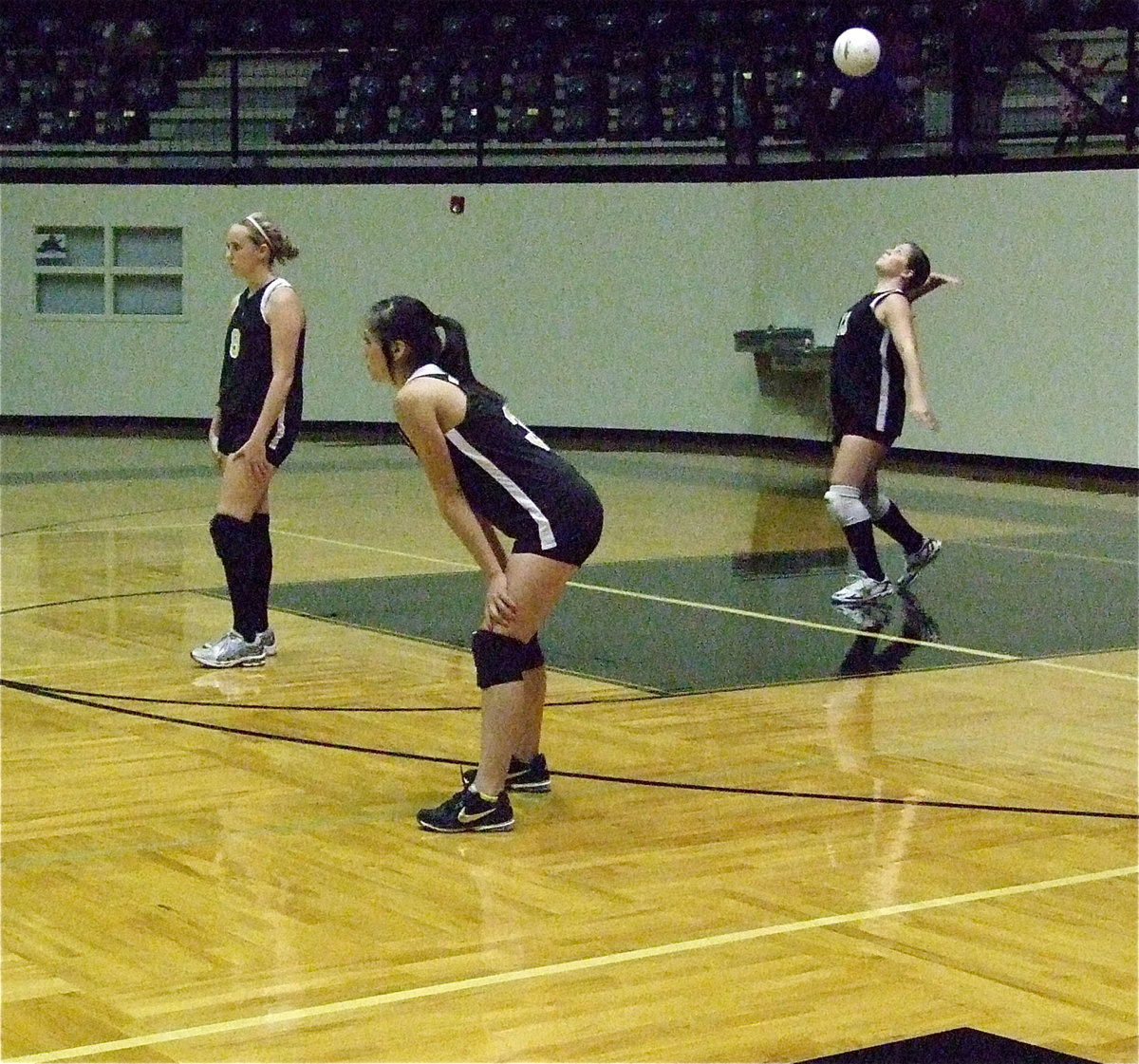 Image: Kelsey Nelson and Paola Mata get set while teammate Reagan Adams serves up a winner.