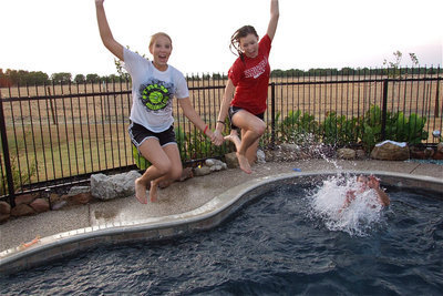 Image: Megan Richards and Kaitlyn Rossa plunge into the pool.