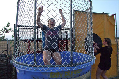 Image: Maddie Pittman decides on a faster technique to dunk schoolmate, Reagan Adams, in the dunking booth.