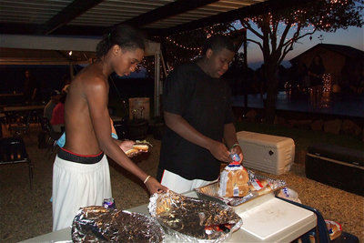 Image: Trevon Robertson and Adrian Reed take a food break from swimming.
