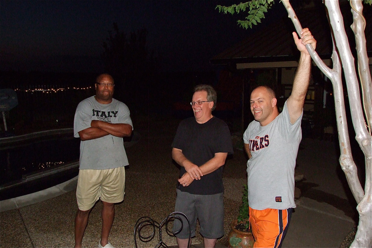 Image: Italy ISD Coach Larry Mayberry, Sr., Superintendent Barry Bassett and Principal Lee Joffre relax poolside as the Italy High School Back-to-School Bash nears the end.