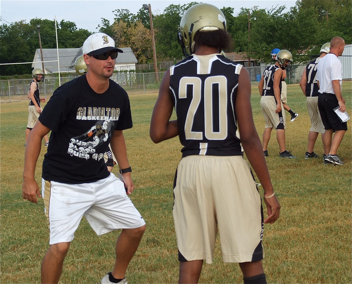 Image: Coach Aidan Callahan talks things out with Trevon Robertson.