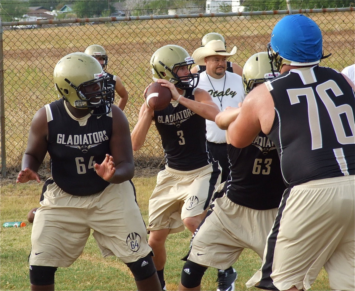 Image: Adrian Reed and Brandon Souder drop back to pass protect for quarterback Jase Holden.