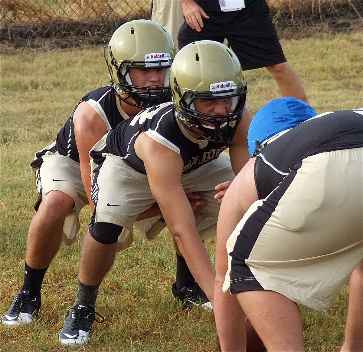 Image: Center, Brandon Souder, snarls while quarterback, Jase Holden, calls the cadence.