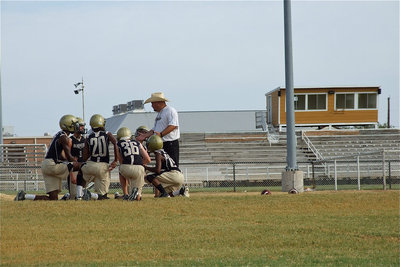 Image: Gladiator head coach, Craig Bales, talks strategy with his defensive backs.
