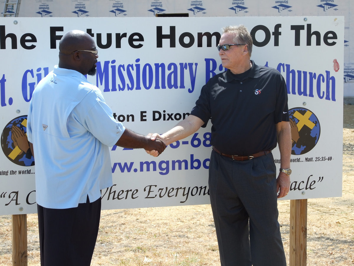 Image: Pastor Dixon welcomes Toby  Collins to the new sanctuary.