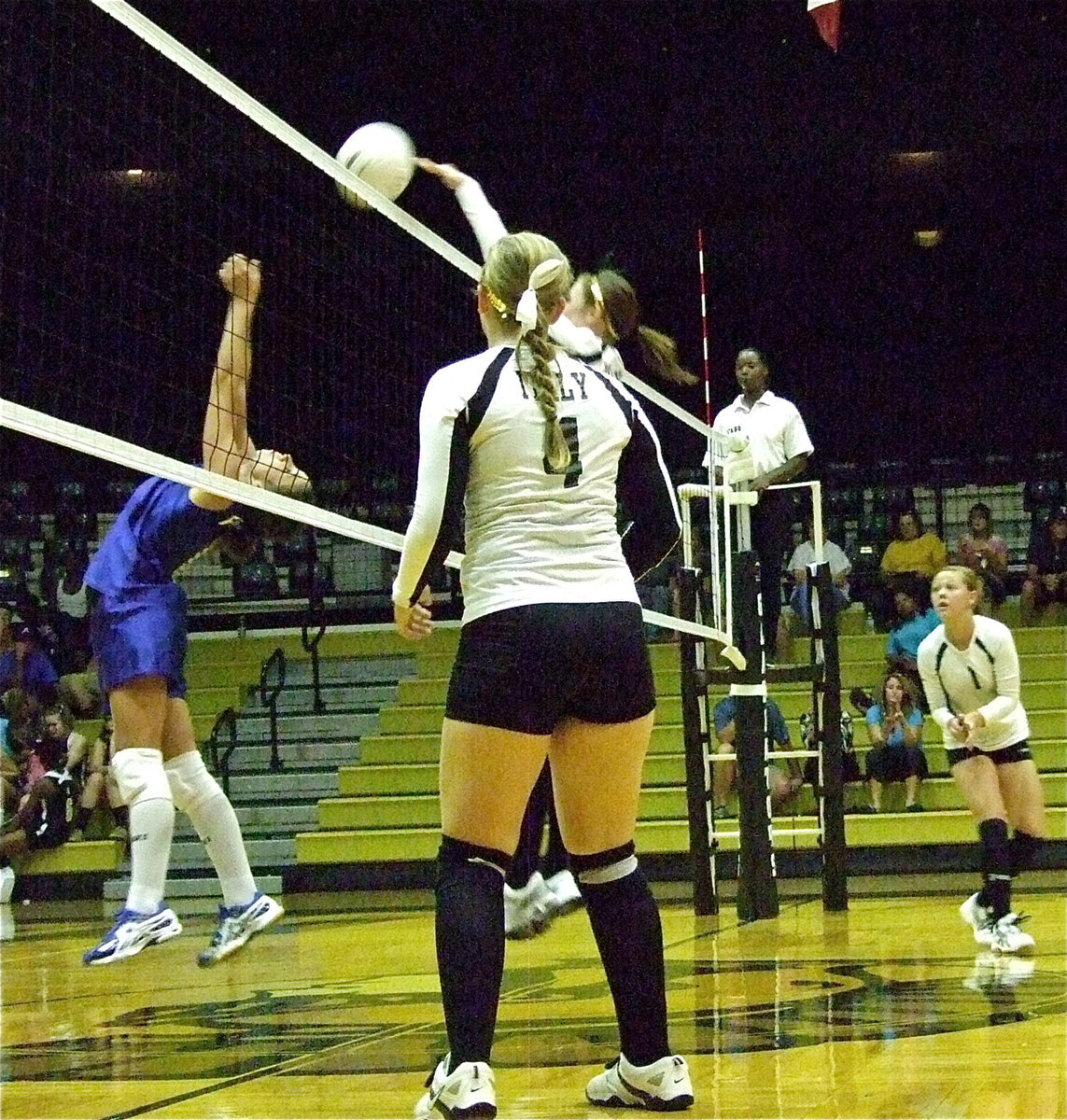 Image: Jaclynn Lewis(4) and Bailey Eubank(1) watch teammate Kaitlyn Rossa(3) battle at the net against Frost.