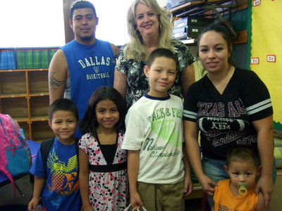 Image: Debra Nelson with her new students and their parents. Lower first row is: Anthony Narvaiz, Katelin Narvaiz, Diego Gomez Angelia Narvaiz and Ayden Narviz. Top row is Mr. Narvaiz and first grade teacher Debra Nelson.