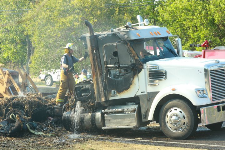 Image: Fire crews look over the damage.