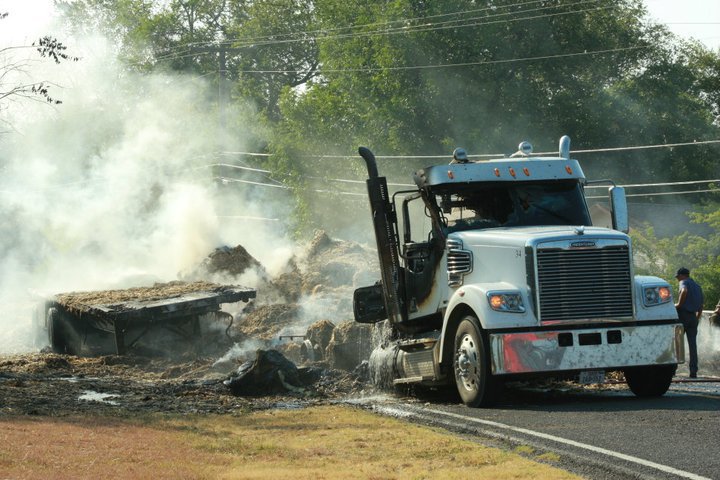 Image: It was quite a scene as the smoldering hay lofts smoke into the air.