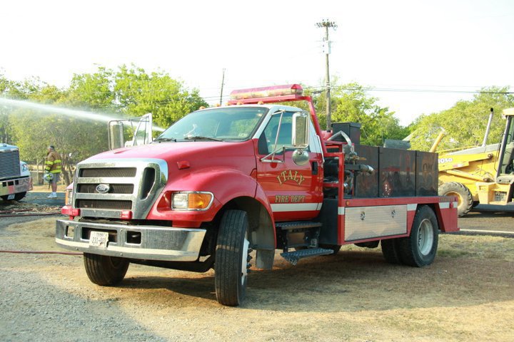 Image: The Italy Fire Department helps water down the smoldering truck.