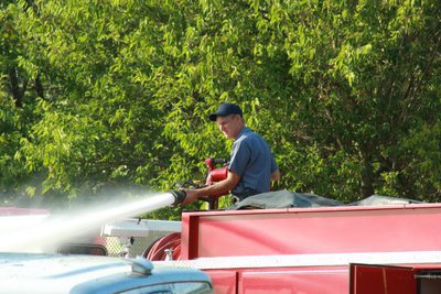 Image: Italy volunteer fire fighter, Randy Boyd, mans the water gun.