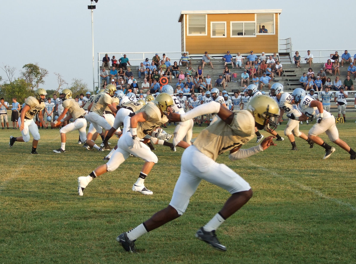 Image: Off to the races. Italy center, Brandon Souder(58), snaps the ball to start the play.