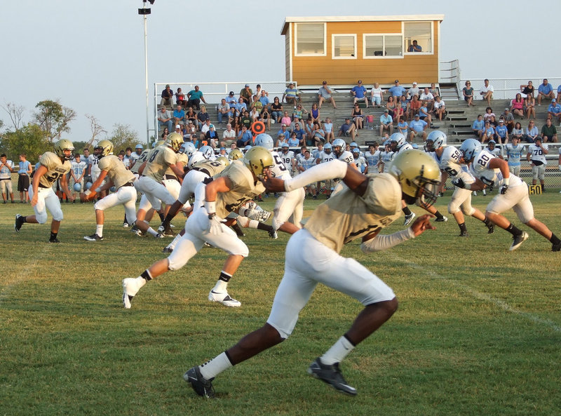 Image: Off to the races. Italy center, Brandon Souder(58), snaps the ball to start the play.