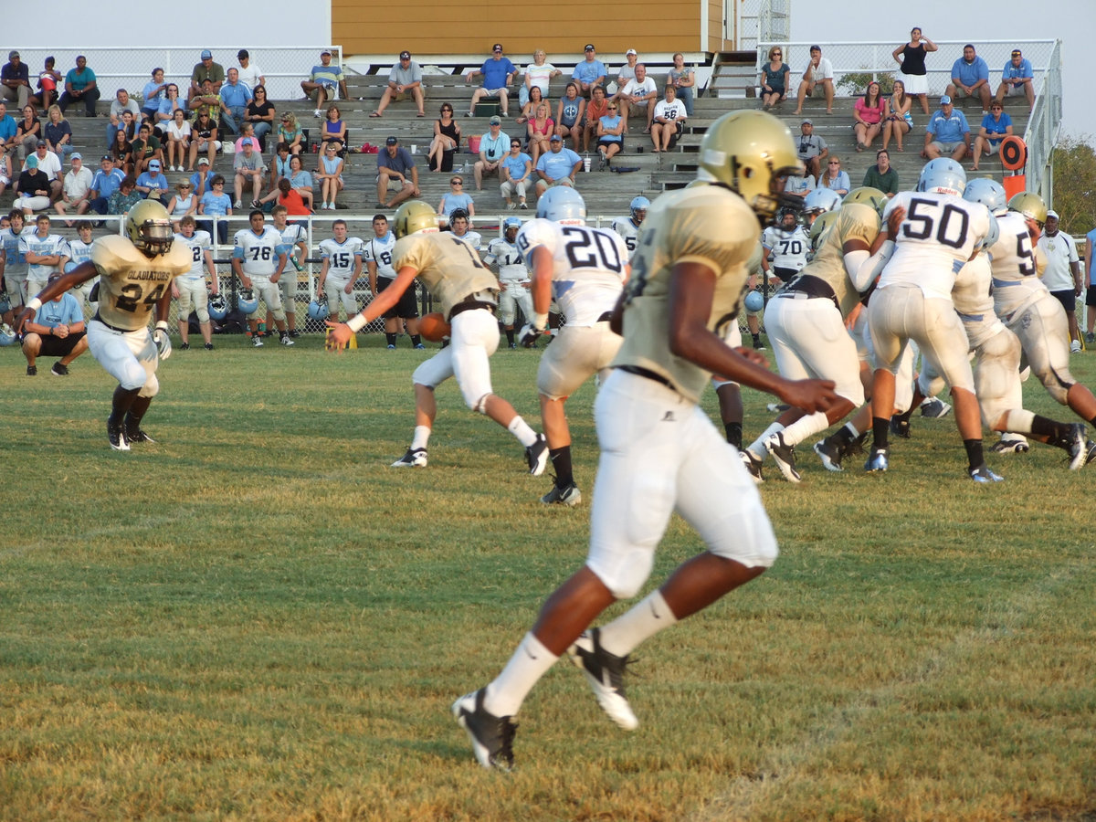 Image: Gladiator quarterback Jase Holden(7), hands off to Ryheem Walker(24), or does he?