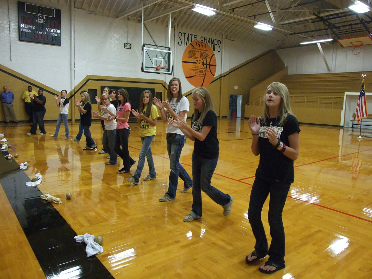 Image: After the introductions, the cheerleaders gave t-shirts and footballs to the crowd.