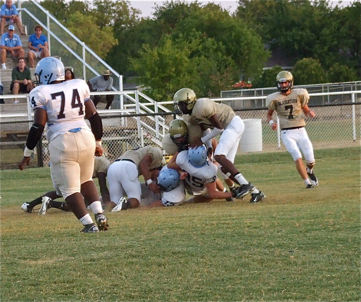 Image: Gladiators Ryheem Walker, Omar Estrada, Ethan Saxon and Devonta Simmons try to hold back the Cougars.