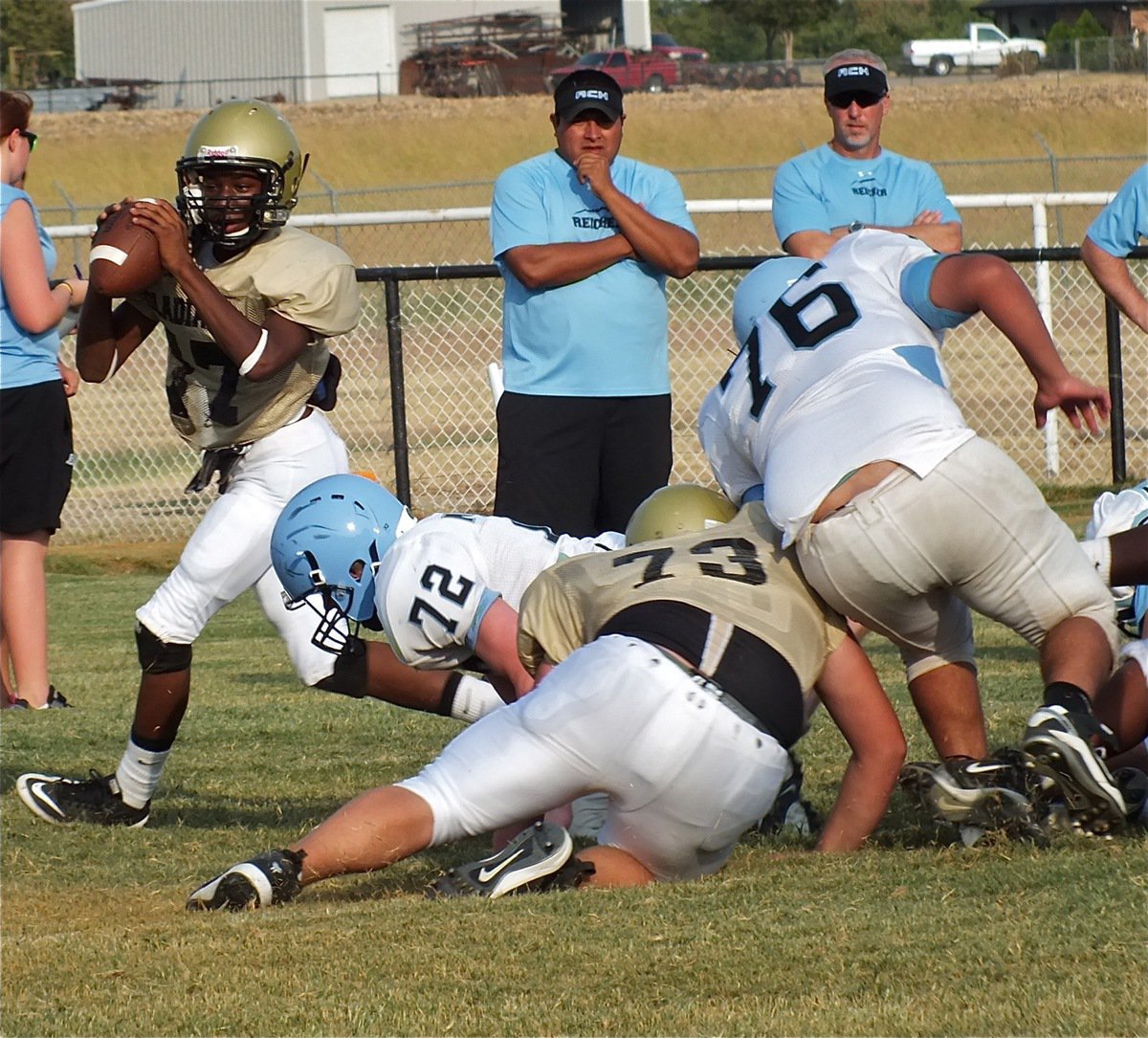 Image: Kelton Bales(73) slows down the Cougar defense as quarterback, Eric Carson(17), drops back in the pocket.