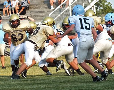 Image: Cody Medrano(28) seals the end while pulling guard, Darol Mayberry(63), locks onto his prey.