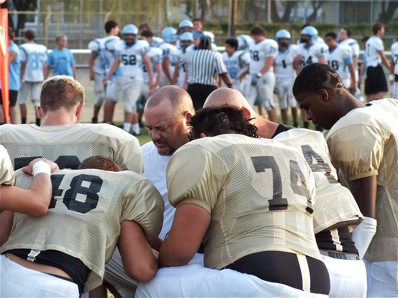 Image: Gladiator head coach, Craig Bales, takes a moment with his varsity before their start of their scrimmage against Waco Reicher.