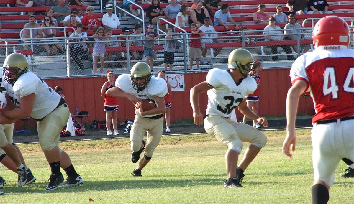 Image: Hank Seabolt(76) and Cody Medrano(32) helped to create a gaping hole for quarterback Justin Wood(48) to run thru.