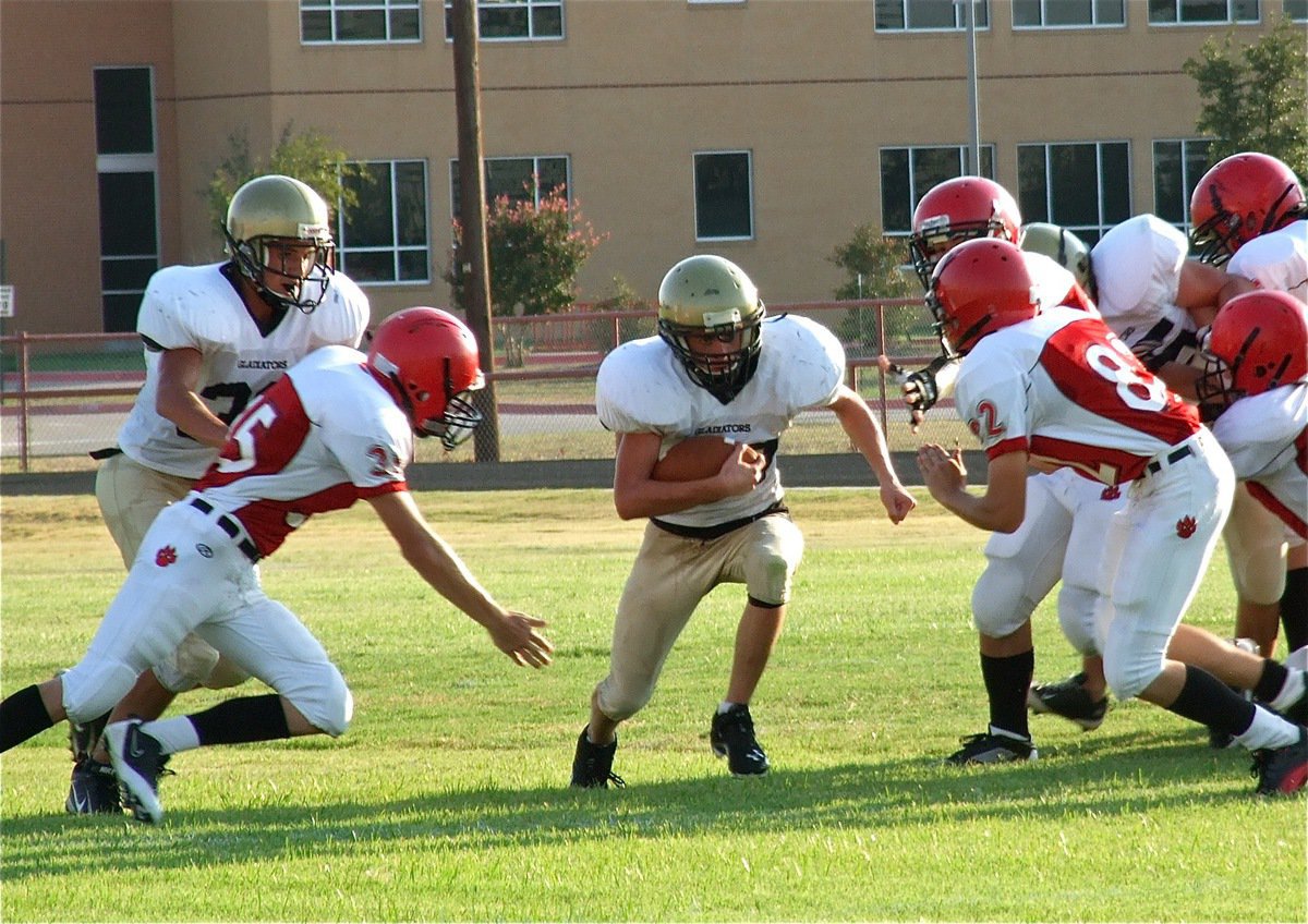 Image: Cody Medrano(32) and Kelton Bales(75) get quarterback Justin Wood(48) to the next level.