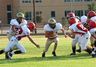 Image: Cody Medrano(32) and Kelton Bales(75) get quarterback Justin Wood(48) to the next level.