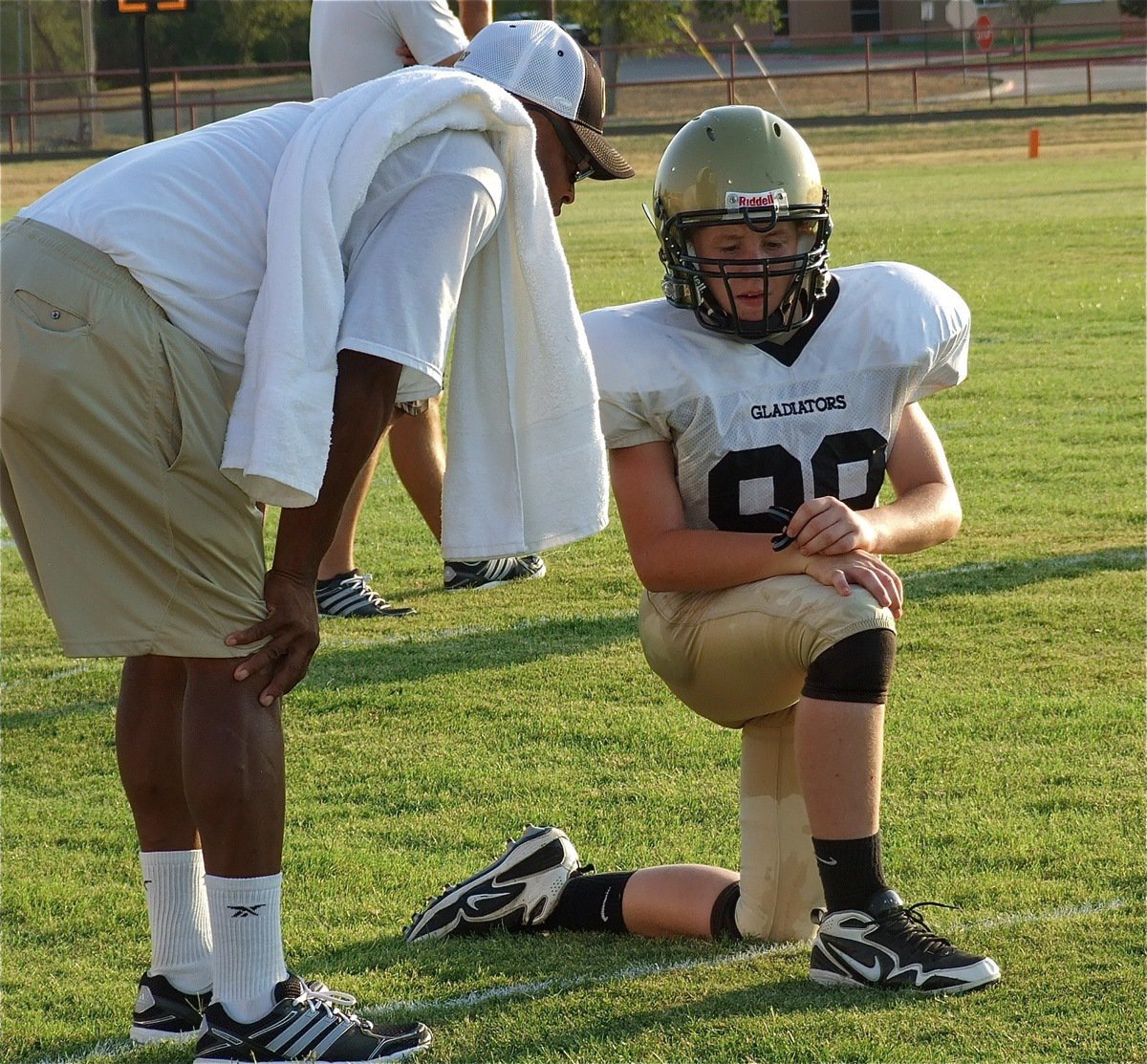 Image: Larry Mayberry, Sr., talks with his kicking ace, John Escamilla.