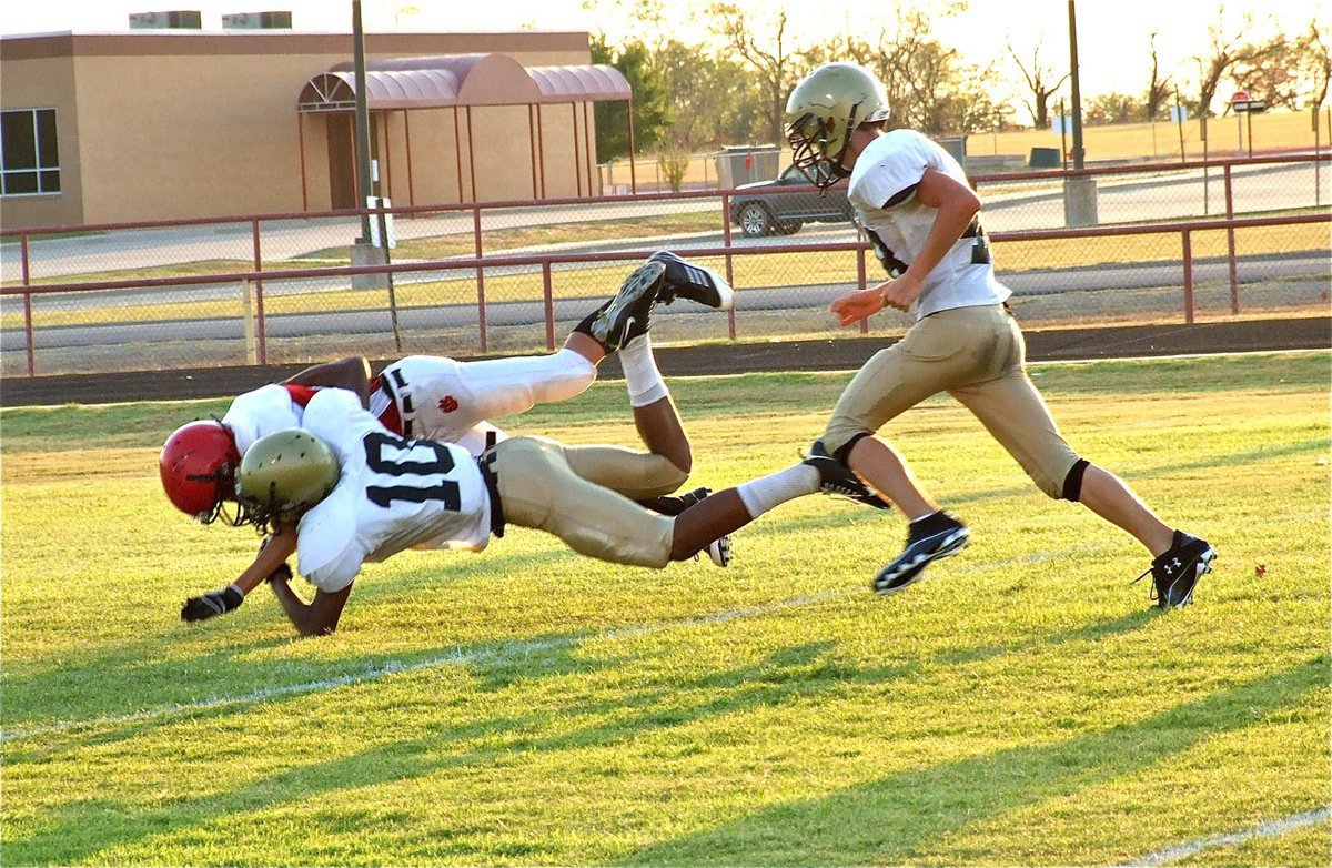 Image: Trevon Robertson(10) launches and drives Maypearl’s kick returner backwards.