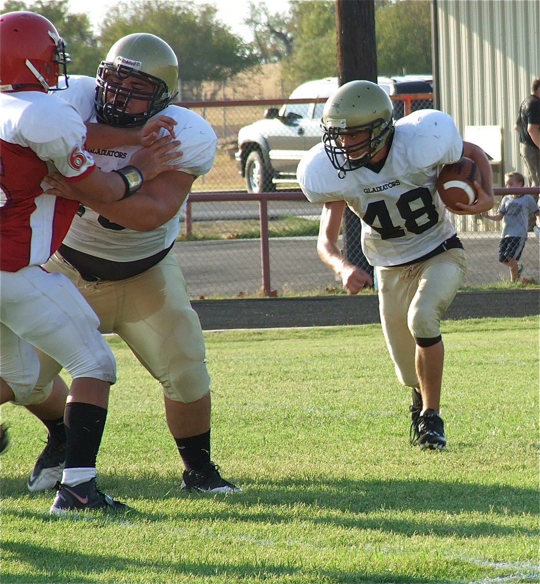 Image: Hank Seabolt(76), fends off a Panther tackler to help Justin Wood(48) gain ground.