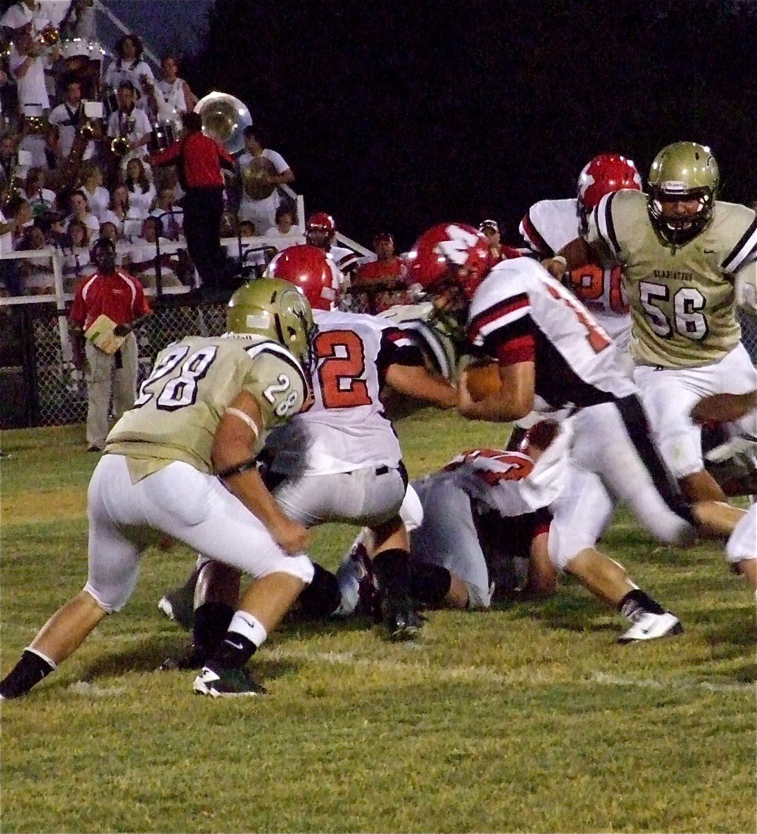 Image: Gladiator linebacker Kyle Jackson(28) fills the hole and puts a lick on Panther quarterback Frank Morphis(14)