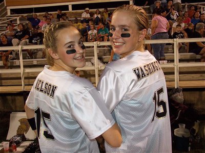 Image: Italy High School cheerleaders Kelsey Nelson and Madison Washington display their game jerseys.