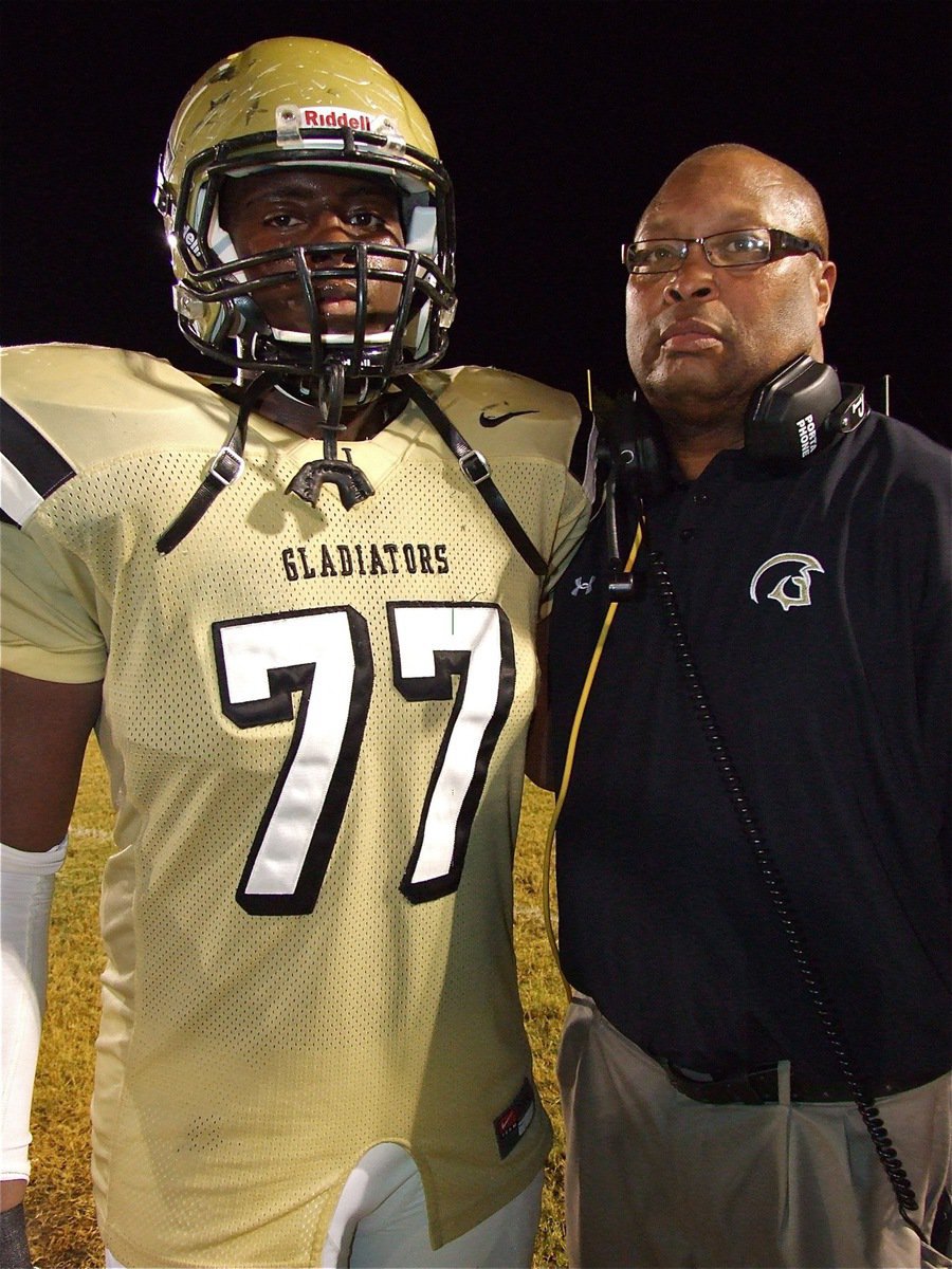 Image: Larry Mayberry, Jr. stands tall with his father, Gladiator assistant coach Larry Mayberry, Sr., as the pair bask in the glow from the Friday night lights and a 30-0 win over Maypearl.