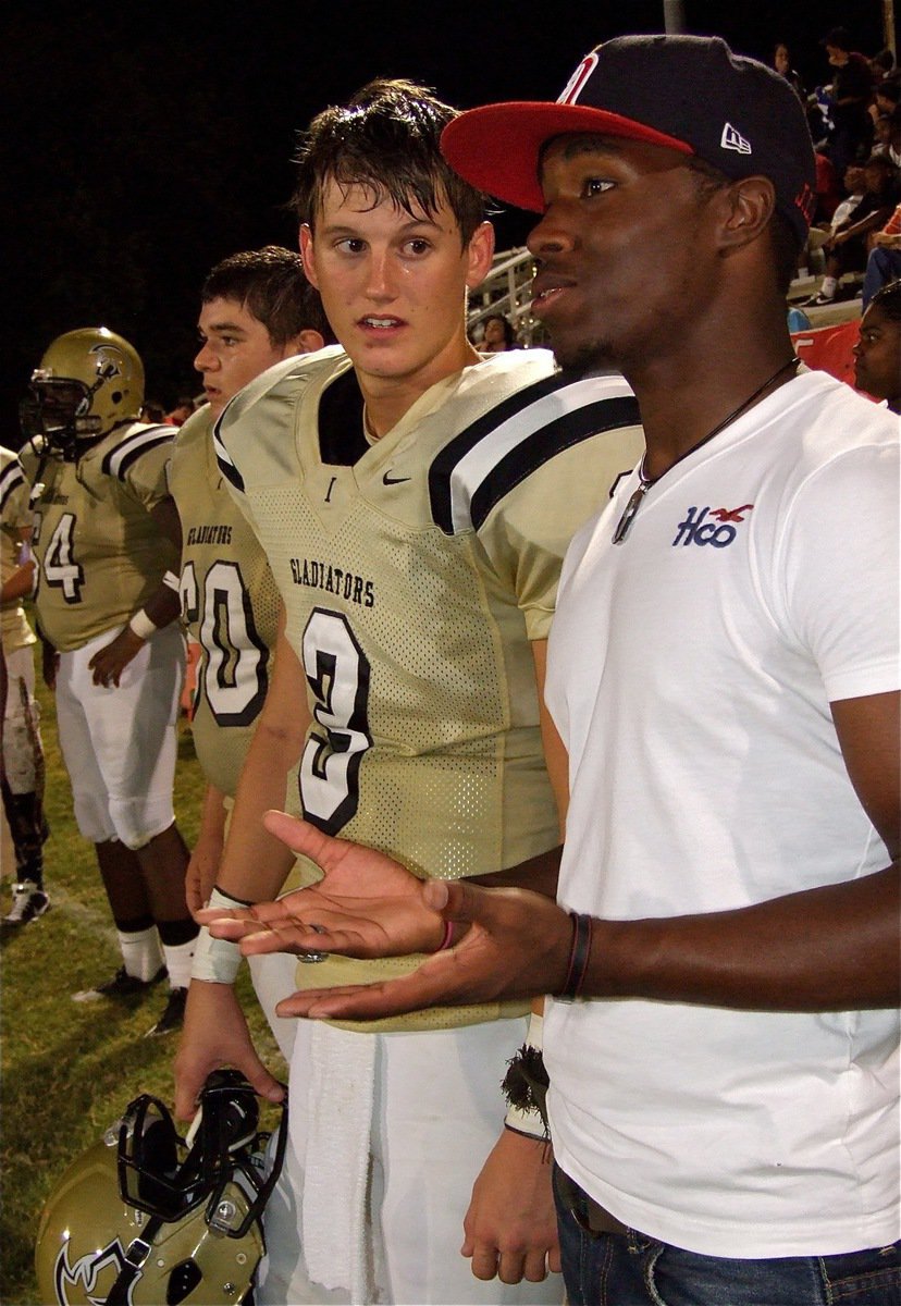 Image: Jase Holden(3) absorbs advice from last season’s quarterback Jasenio Anderson.