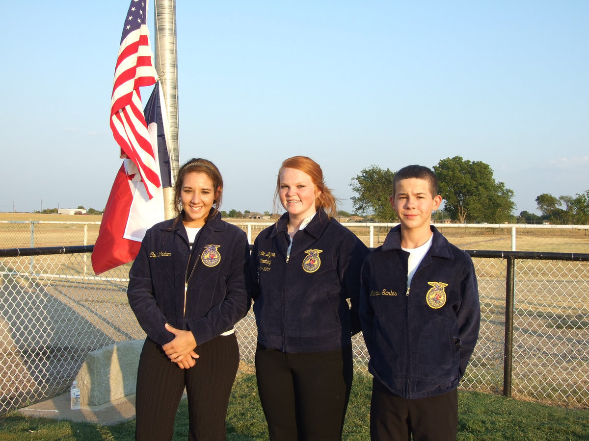 Image: Alyssa Richards, Katie Byers and Marcus Sorels raise the flag and represent Italy FFA.