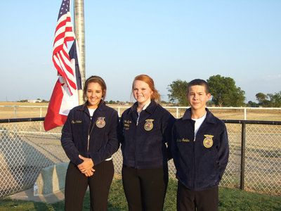 Image: Alyssa Richards, Katie Byers and Marcus Sorels raise the flag and represent Italy FFA.